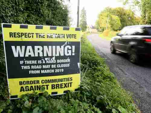 Brexit warning sign on road running across the Ireland-Northern Ireland border (AFP)