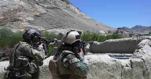 An Afghan command and a US Special Forces soldier scan the horizon for enemy movement in Afghanistan, on May 24, 2018. (Military Times)