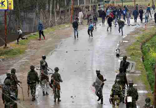 A group of youth pelt stones at Indian security forces in Budgam on Tuesday (PTI)