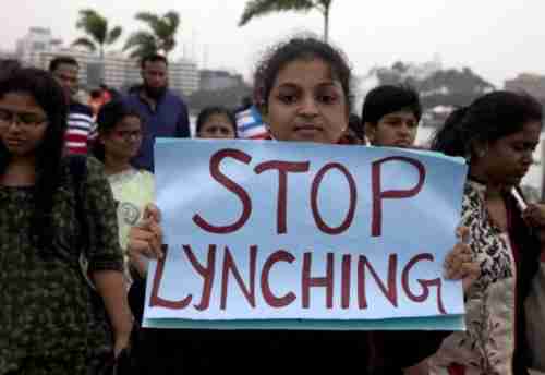 A protester in Hyderabad, India, on Wednesday holds up a sign saying 'Stop Lynching' (AP)