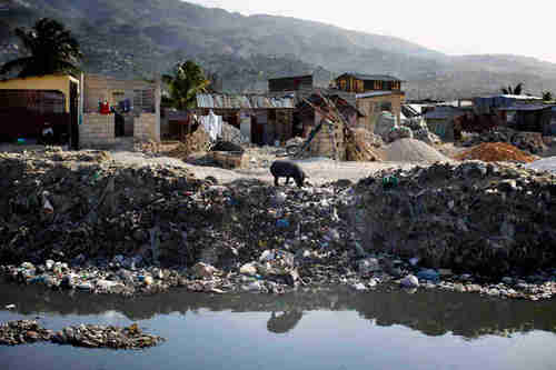 People dump trash and raw sewage into canals that run through Port-au-Prince, Haiti. When it rains, the canals overflow and flood poor neighborhoods. (NPR)