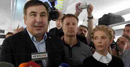  Mikhail Saakashvili (L) is joined by Ukraine's former prime minister Yulia Tymoshenko (R) and other supporters on Sunday after entering Ukraine from Poland (AFP)