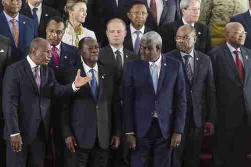  Guinea's President Alpha Conde, front row left, speaks with Ivory Coast President Alassane Ouattara, front row middle, and African Union Commission chairman Moussa Faki, front row center, during group photo on Wednesday at AU-EU Summit. (AP)