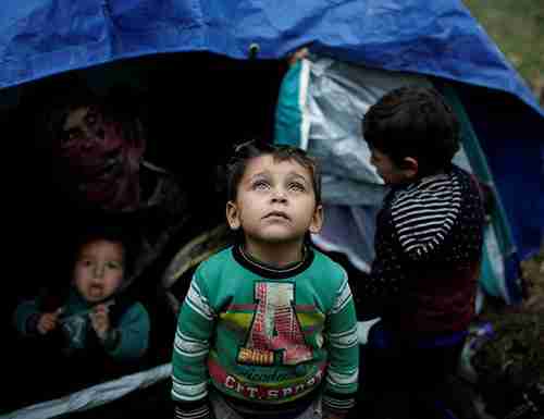 Child migrant in Greek refugee camp (AFP)