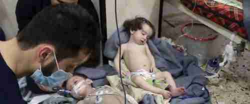 Medical workers treat toddlers following chlorine gas attack in Douma, Syria, on Sunday (AP)
