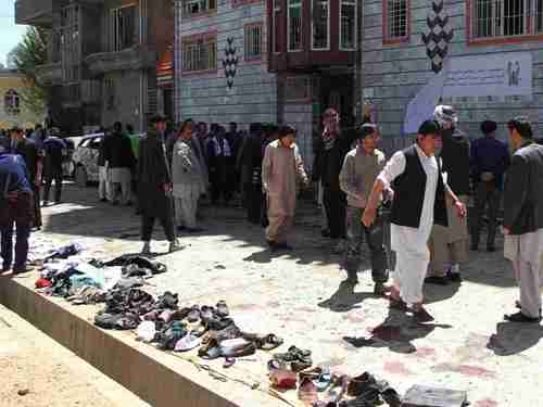Clothes and shoes are seen at the site of a suicide bomb attack in Kabul, Afghanistan, on Sunday. The items were placed in a row for the victims' families to claim afterwards. (Getty)