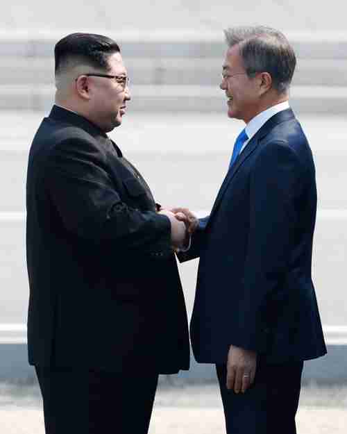 South Korean President Moon Jae-in and North Korean leader Kim Jong-un shake hands in front of Freedom House at Panmunjeom, Friday. (Korea Times)