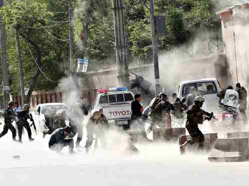 Security forces run from the second coordinated suicide attack bombing in Kabul on Monday (AP)