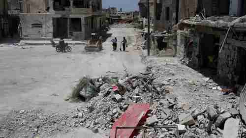 A bulldozer clears debris from the streets in Deraa, Syria July 25, 2017 (Reuters)