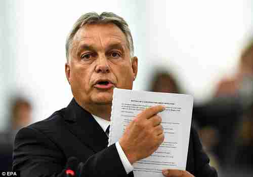 Hungary's Prime Minister Viktor Orbán points to a document during Tuesday's speech to European Parliament (EPA)