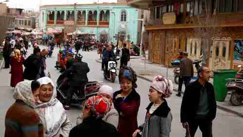 Uighur people mingle in the old town of Kashgar, Xinjiang, China on March 22, 2017 (Reuters)