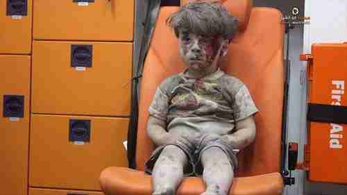 From August 2016: Five year old boy, Omran Daqneesh, sitting confused in an ambulance in Aleppo after being pulled from the rubble of one of Bashar al-Assad's airstrikes. To al-Assad, this boy and others like him are just cockroaches to be exterminated.