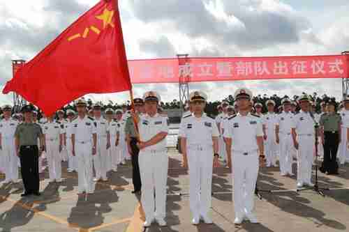 Chinese soldiers stand guard at a military port in Zhanjiang, Guangdong province, on Tuesday, as warships with soldiers depart for Djibouti (Reuters)